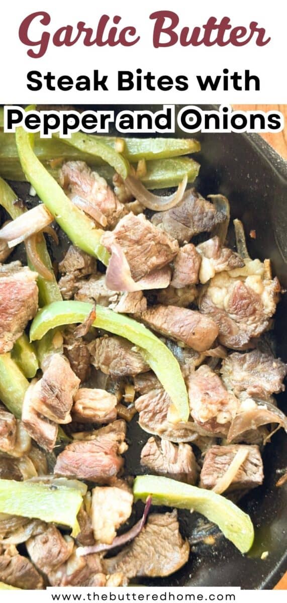 A skillet filled with cooked steak bites, sliced green bell peppers, and onions. The text above the image reads "Garlic Butter Steak Bites with Pepper and Onions." Website "thebutteredhome.com" is at the bottom.