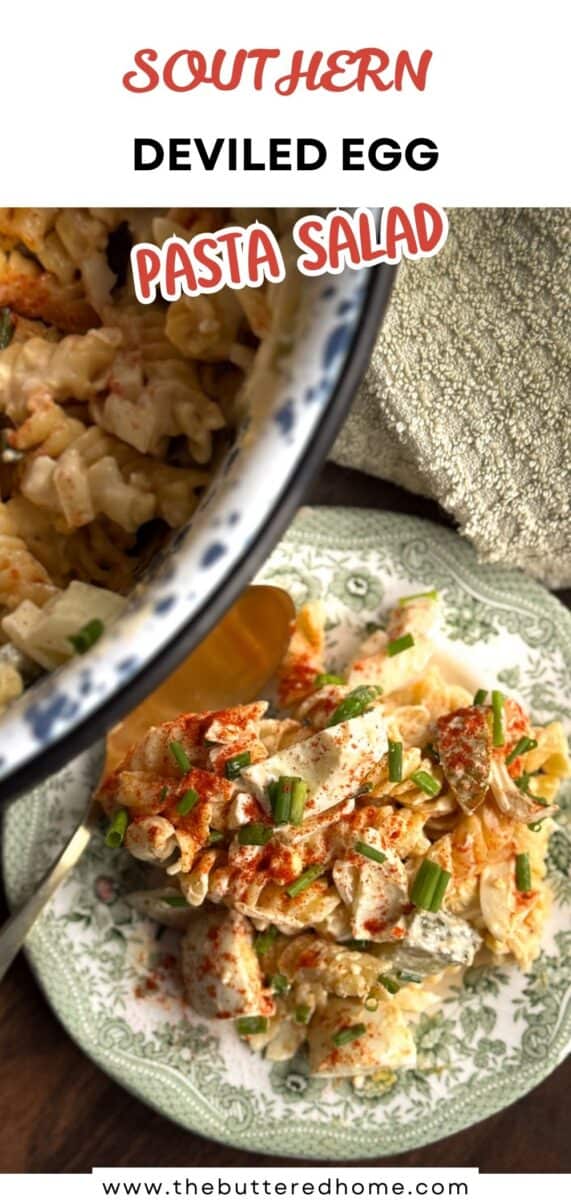 A serving of Southern deviled egg pasta salad sits on a green patterned plate, topped with chopped chives and paprika. A pan with more salad is visible in the background. Text reads "Southern Deviled Egg Pasta Salad".