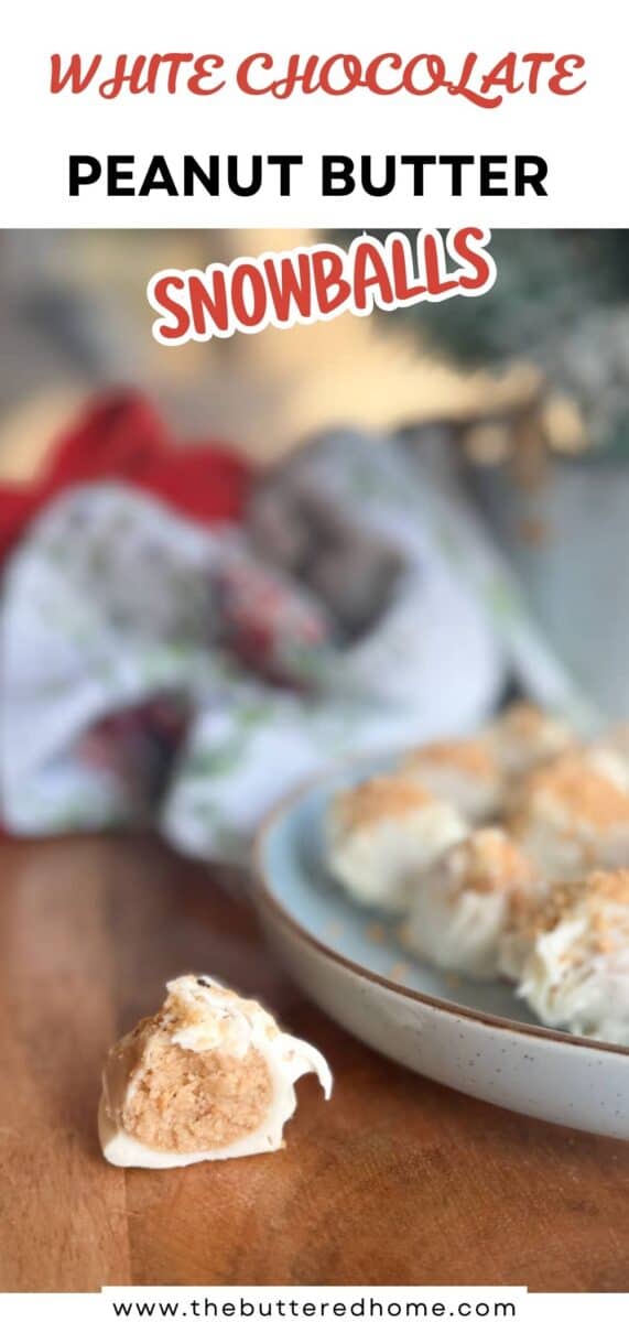 A close-up of a white chocolate peanut butter snowball on a wooden surface, with more snowballs on a plate in the background. Text at the top reads “White Chocolate Peanut Butter Snowballs.”.