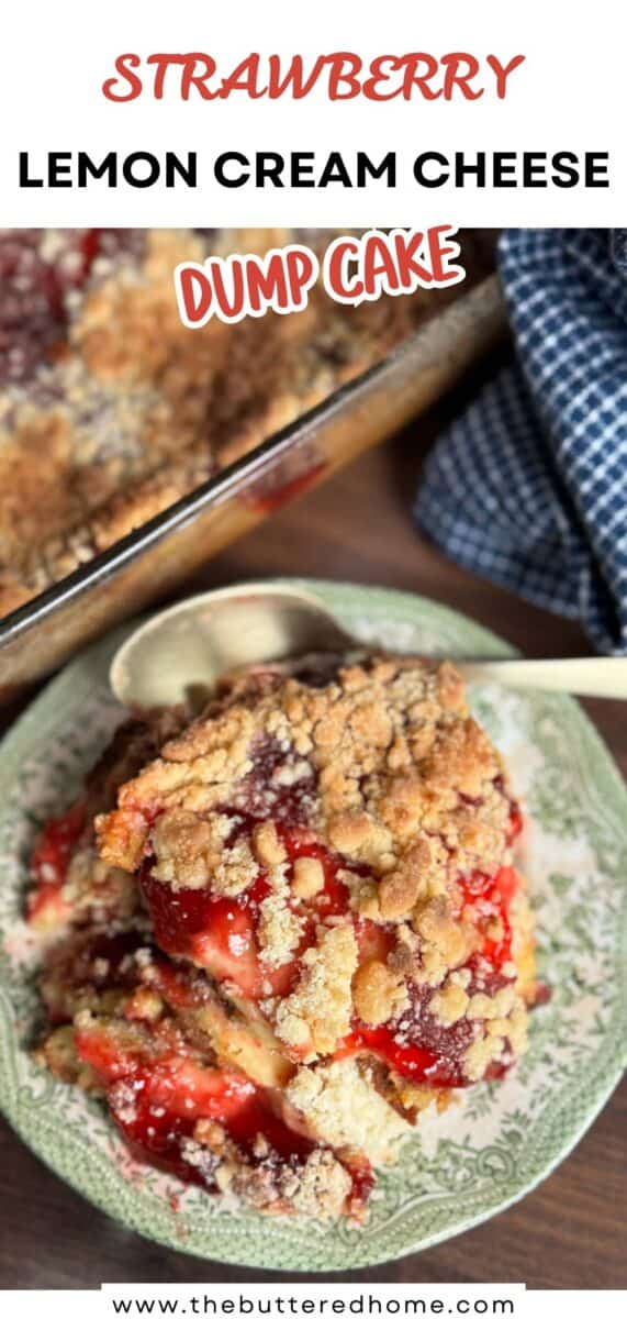A slice of strawberry lemon cream cheese dump cake sits on a floral plate with a spoon. The cake has a crumbly topping and visible strawberry filling. Part of the cake in a glass baking dish is in the background.