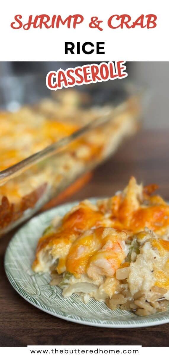 A close-up of a serving of shrimp and crab rice casserole on a green plate, with the casserole dish in the background. The dish appears cheesy and baked, featuring visible pieces of shrimp and crab.