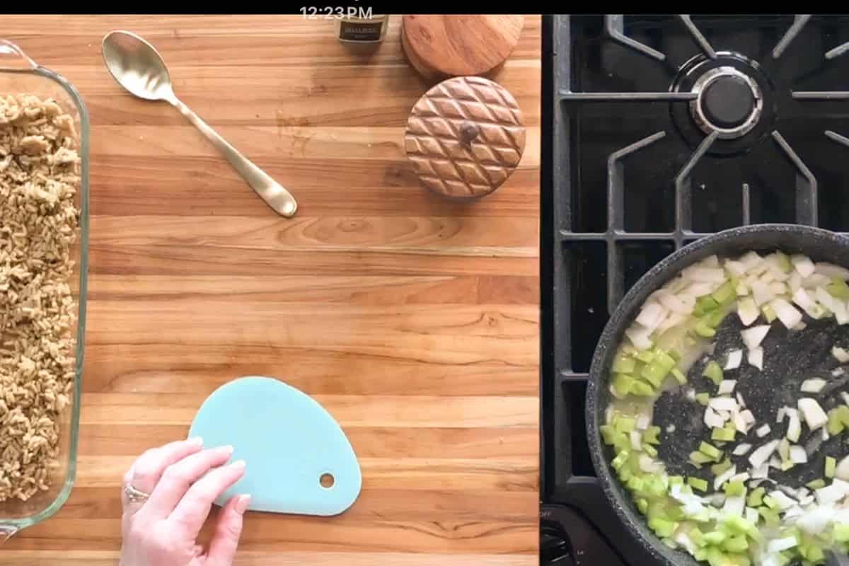A split screen shows a glass dish with crumb mixture and a spoon on a wooden surface on the left, and chopped onions and celery sautéing in a skillet on a gas stove on the right. A hand holds a blue scraper.